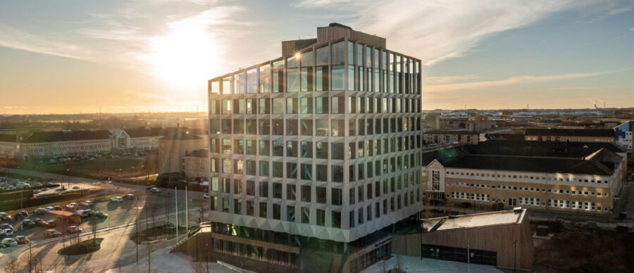 Modern office building in Høje-Taastrup bathed in golden hour sunlight