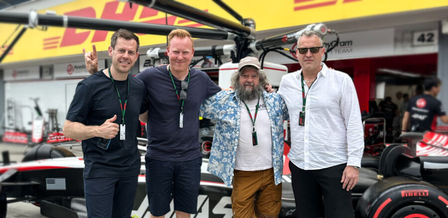 Stig Larsen, Anders Breinholt and Anders Lund Madsen at a Formula 1 pit lane with the Haas F1 Team