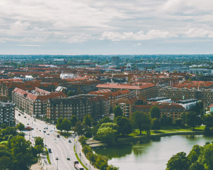 Aerial view of red-roofed buildings and green parklands in Copenhagen, Denmark