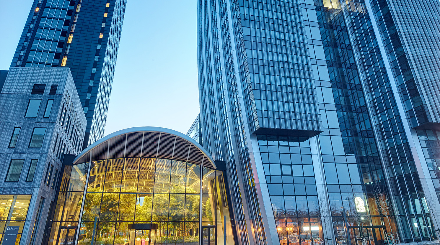 Modern glass-fronted entrance to Copenhagen Towers, home of Intellis A/S headquarters in Ørestad, Copenhagen.