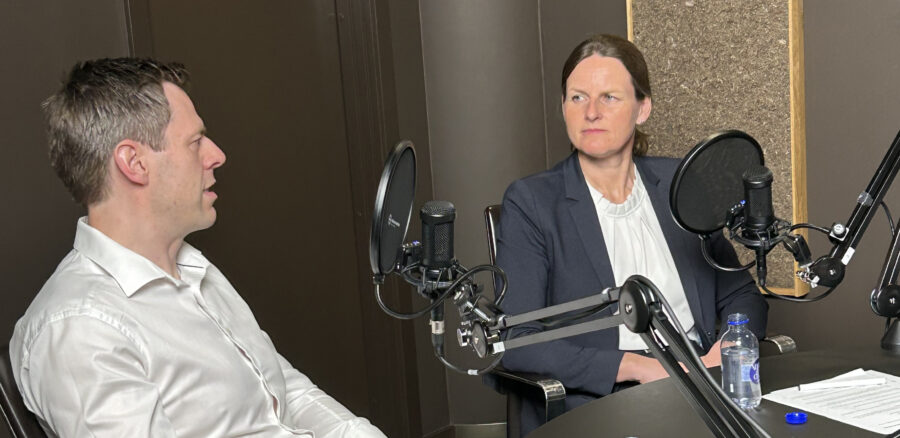 Stig Larsen and Rikke Hougaard Zeberg recording a professional podcast interview in a studio setting