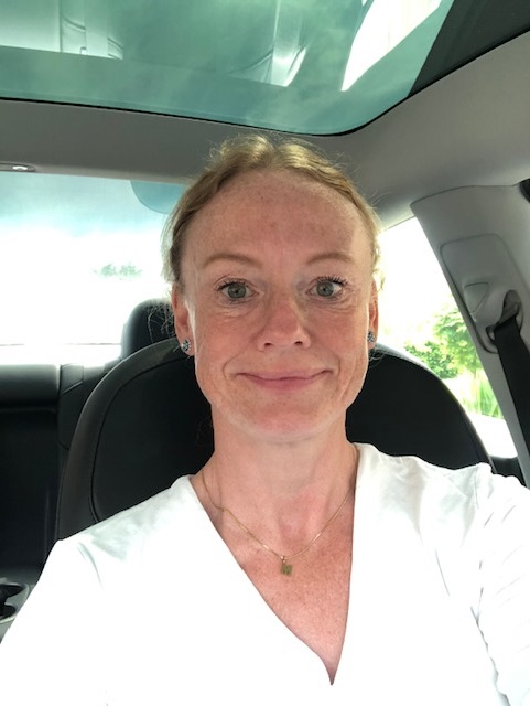 Maja Clausen, Sales Manager at Intellis, smiling inside a car.