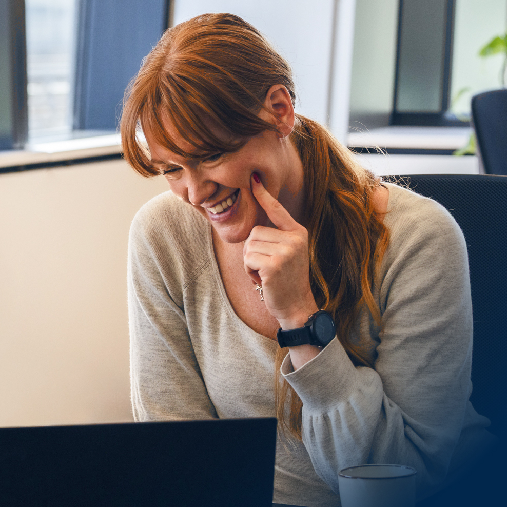 Smiling woman participating in an online meeting at Intellis.