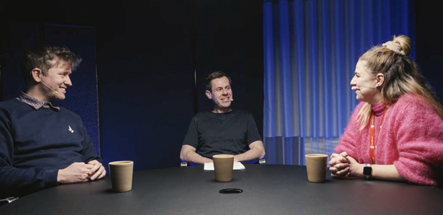 Three people in a podcast studio, smiling and engaged in discussion about digital parenting, gaming, and online safety.
